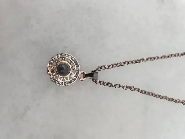 Rose gold tone sun and moon projection necklace