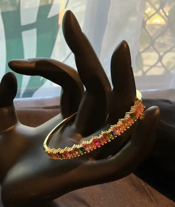 Gold tone stainless steel multicoloured crystal hinged bangle bracelet