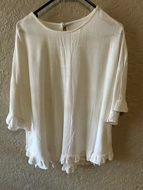 Women’s white ruffled tunic style blouse