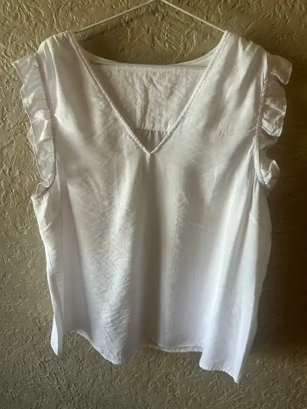 Women’s white ruffled sleeveless blouse