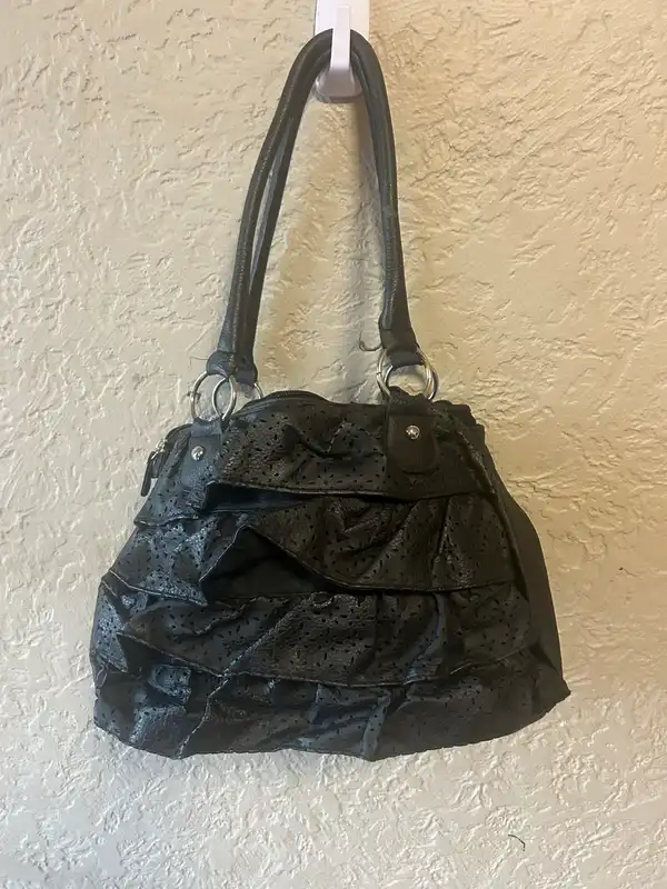 Black shoulder bag with perforated fringes